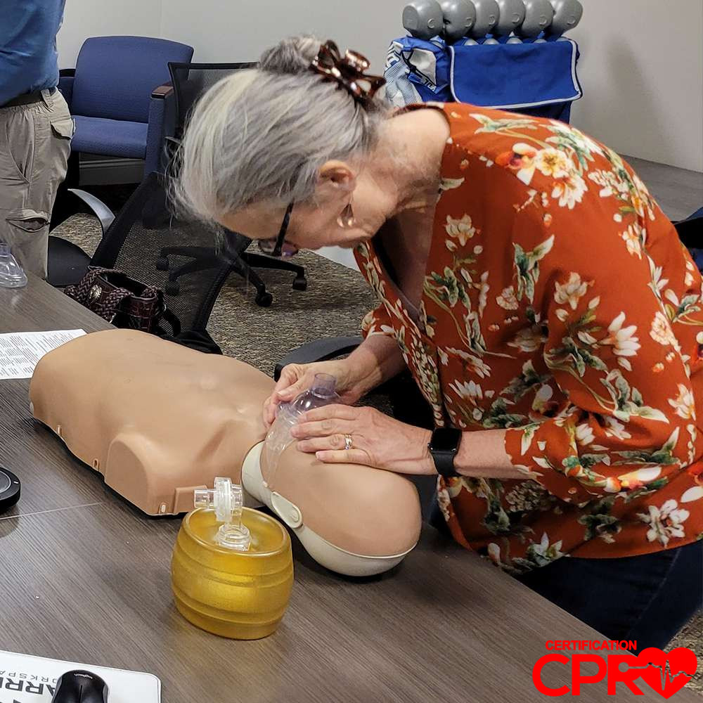 CPR training session with adult mannequin in Baltimore.